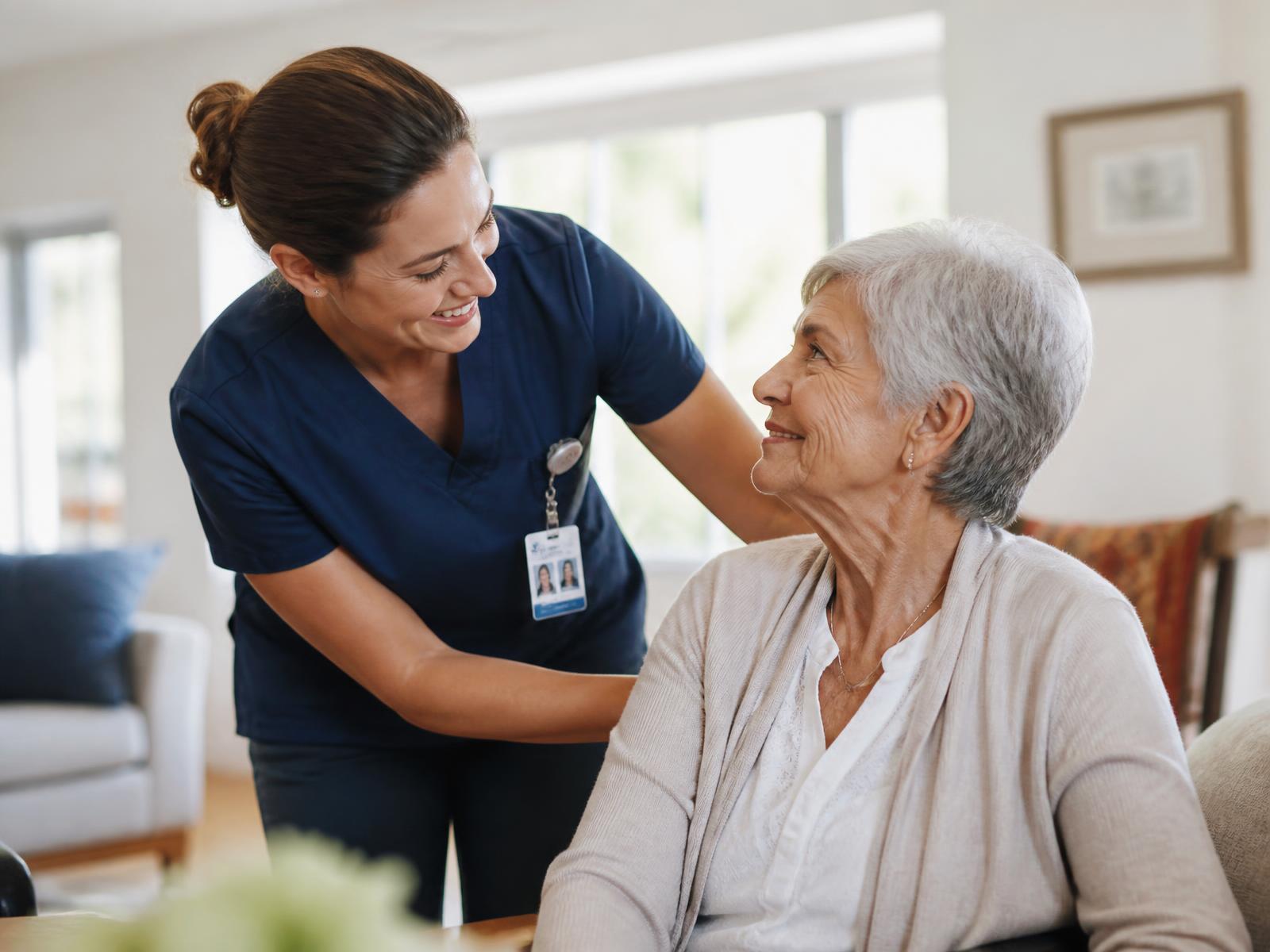 A professional caregiver supporting an older adult in a warm home setting