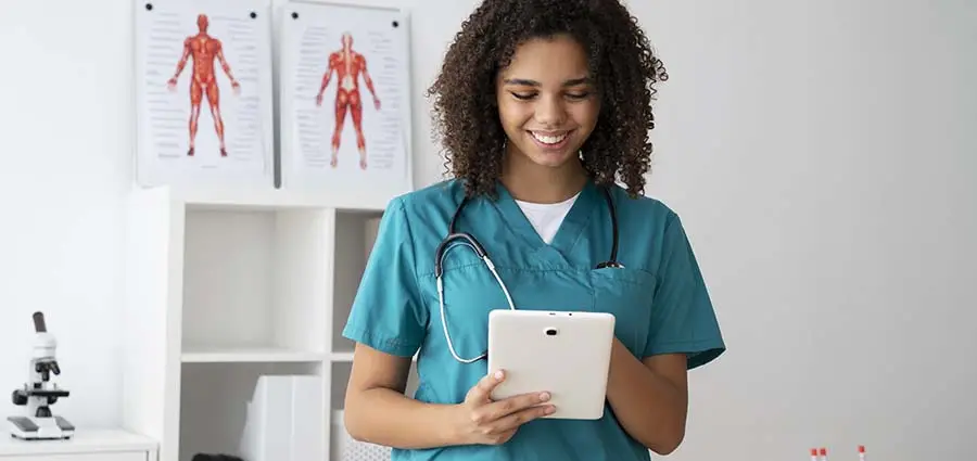 A young caregiver using a tablet to learn a caregiver course online